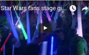 Star Wars fans stage giant lightsaber battle